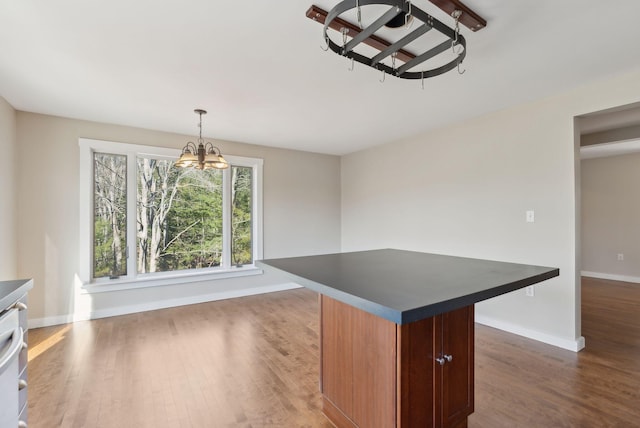 27 Rein Rd, Saint George, ME 04859 - unfurnished dining area featuring baseboards, an inviting chandelier, and wood finished floors