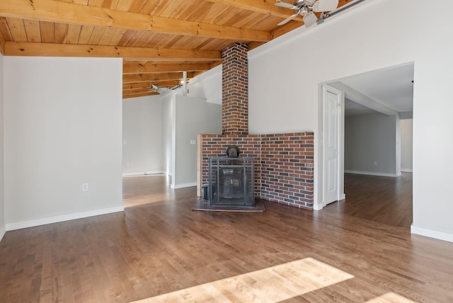 27 Rein Rd, Saint George, ME 04859 - unfurnished living room with wood ceiling, a wood stove, wood finished floors, baseboards, and beamed ceiling