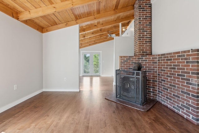 27 Rein Rd, Saint George, ME 04859 - unfurnished living room with lofted ceiling with beams, a wood stove, baseboards, wood finished floors, and wood ceiling