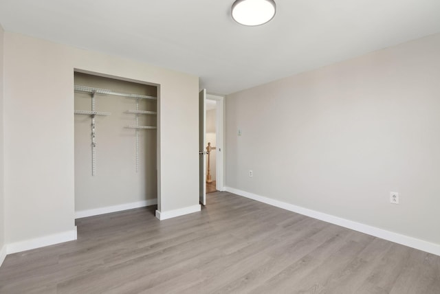 27 Rein Rd, Saint George, ME 04859 - unfurnished bedroom with a closet, light wood-style floors, and baseboards
