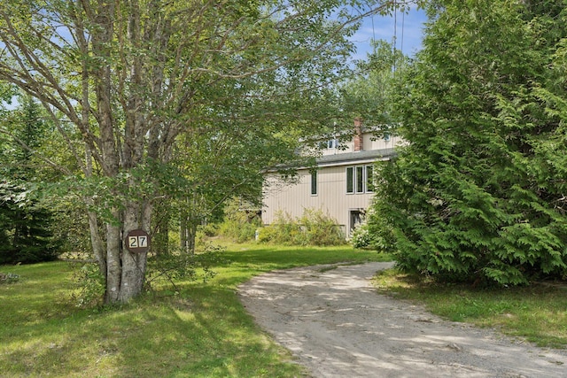 27 Rein Rd, Saint George, ME 04859 - view of front of home featuring dirt driveway, a chimney, and a front lawn