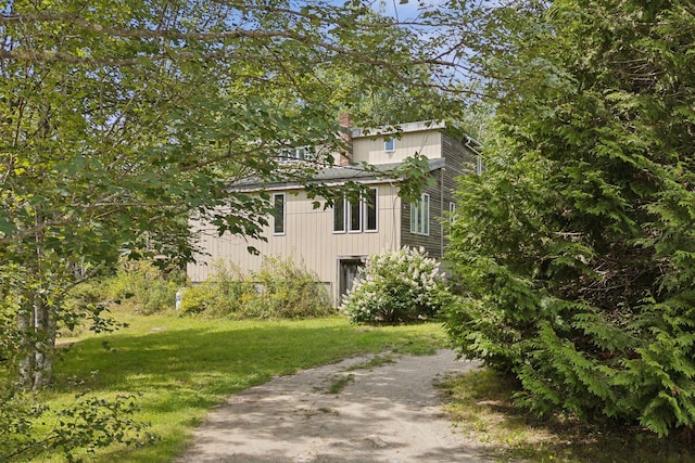 27 Rein Rd, Saint George, ME 04859 - view of home's exterior featuring a lawn and a chimney