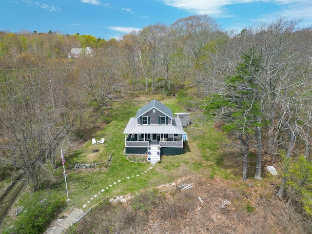 view of subject property with a forest