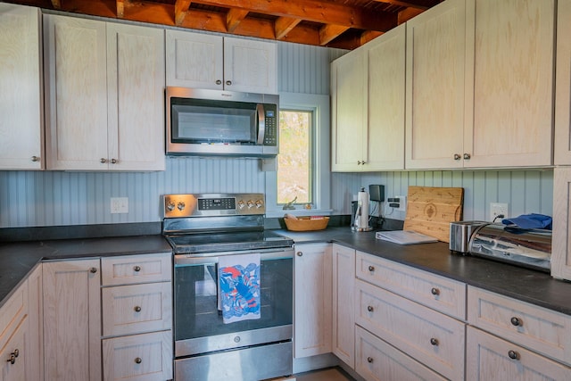 kitchen with appliances with stainless steel finishes and dark countertops