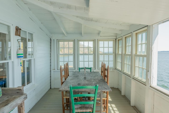 sunroom / solarium with a water view, wood finished floors, wooden ceiling, and french doors