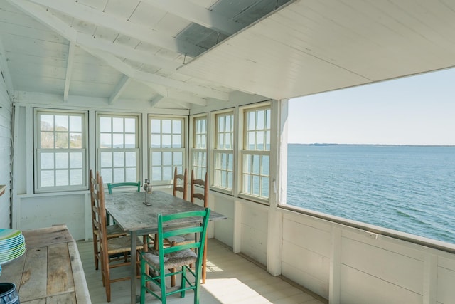 sunroom featuring a water view, wooden ceiling, and wood finished floors