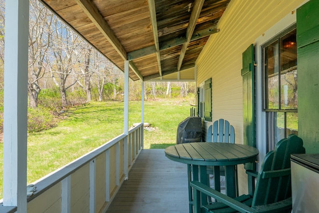 wooden deck featuring a yard
