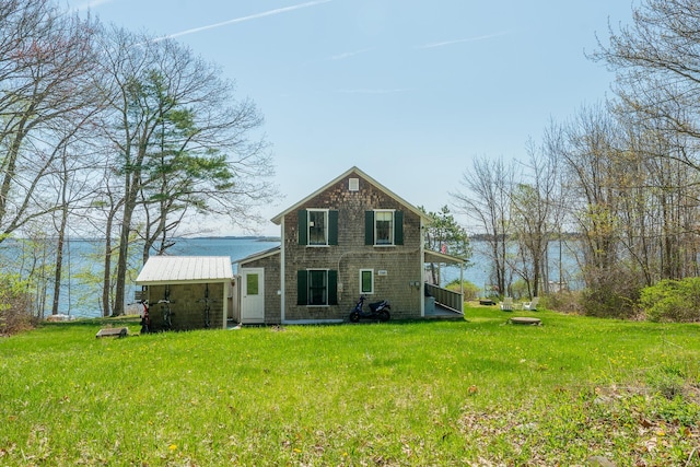 rear view of property featuring a yard