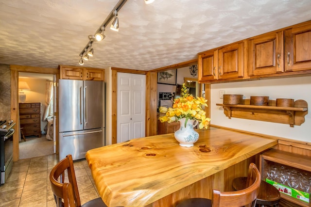 33 Rennie Ln, Brownfield, ME 04010 - dining space featuring rail lighting, a textured ceiling, and light tile patterned floors