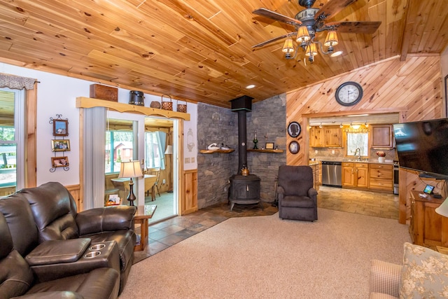 33 Rennie Ln, Brownfield, ME 04010 - living area featuring a wood stove, ceiling fan, lofted ceiling, and a wealth of natural light