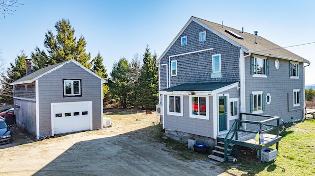 361 Sedgwick Ridge Rd, Sedgwick, ME 04676 - view of property exterior featuring a detached garage, an outdoor structure, and driveway