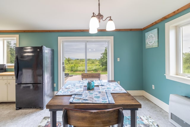 361 Sedgwick Ridge Rd, Sedgwick, ME 04676 - dining space featuring a chandelier, heating unit, and plenty of natural light