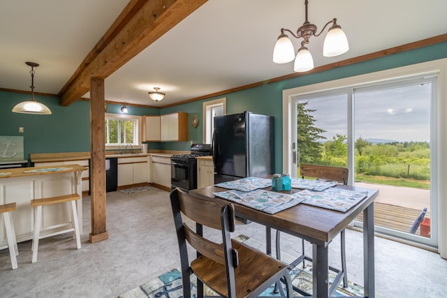 361 Sedgwick Ridge Rd, Sedgwick, ME 04676 - dining area featuring a chandelier, beamed ceiling, and crown molding