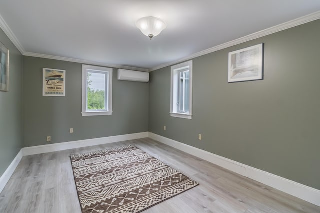 361 Sedgwick Ridge Rd, Sedgwick, ME 04676 - spare room featuring a wall mounted air conditioner, healthy amount of natural light, crown molding, and wood finished floors