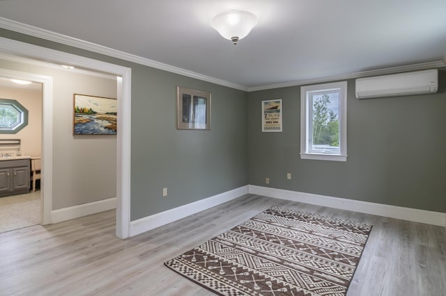361 Sedgwick Ridge Rd, Sedgwick, ME 04676 - below grade area featuring a wall unit AC, light wood-style flooring, and ornamental molding