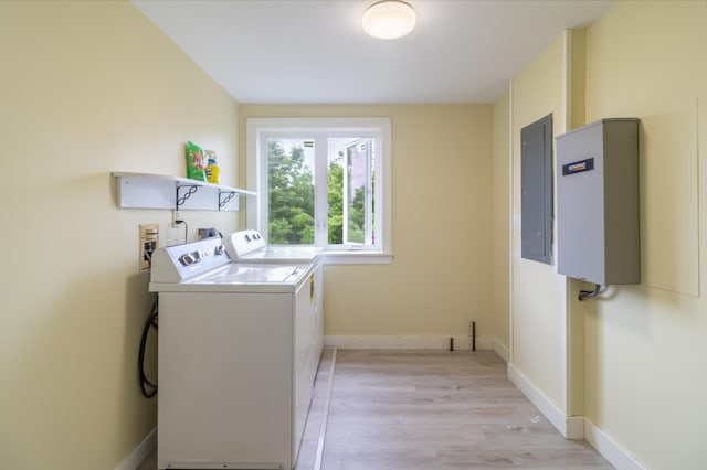 361 Sedgwick Ridge Rd, Sedgwick, ME 04676 - laundry room with electric panel, washer and dryer, and light wood-type flooring