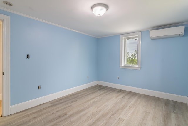 361 Sedgwick Ridge Rd, Sedgwick, ME 04676 - unfurnished room featuring a wall mounted AC, light wood-style floors, and crown molding
