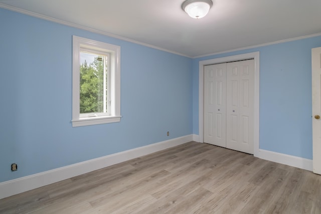 361 Sedgwick Ridge Rd, Sedgwick, ME 04676 - unfurnished bedroom featuring ornamental molding, wood finished floors, and a closet