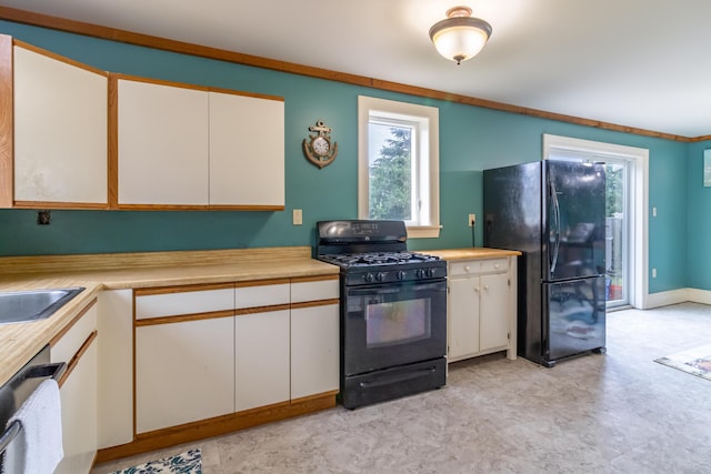361 Sedgwick Ridge Rd, Sedgwick, ME 04676 - kitchen with black appliances, light countertops, plenty of natural light, and white cabinetry