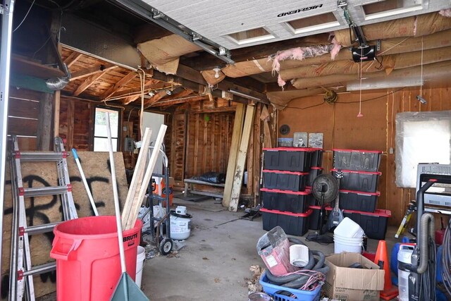 104 Northern Ave, Gardiner, ME 04345 - miscellaneous room featuring a garage, concrete floors, and wooden walls