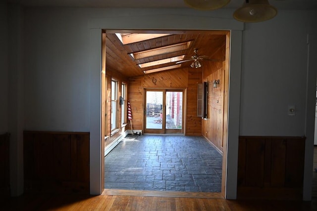 104 Northern Ave, Gardiner, ME 04345 - interior space with ceiling fan, vaulted ceiling with skylight, wood walls, wood finished floors, and wood ceiling