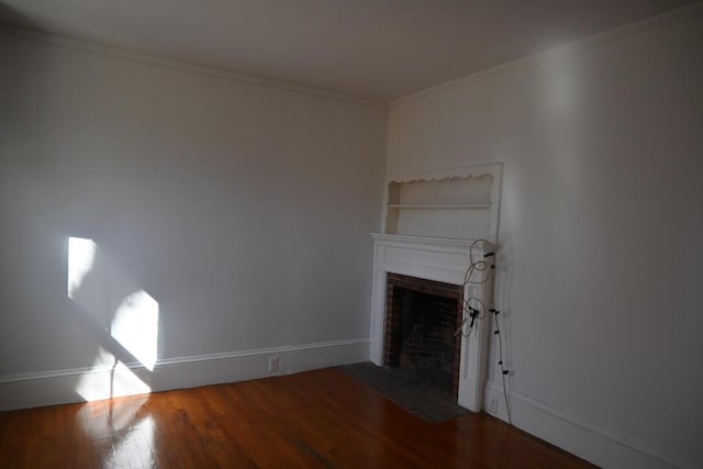 104 Northern Ave, Gardiner, ME 04345 - unfurnished living room with baseboards, ornamental molding, a brick fireplace, and wood finished floors