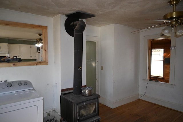 104 Northern Ave, Gardiner, ME 04345 - washroom featuring a wood stove, washer / clothes dryer, wood finished floors, and ceiling fan