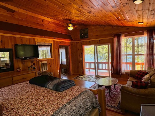 bedroom with wood walls, access to exterior, wooden ceiling, wood finished floors, and lofted ceiling
