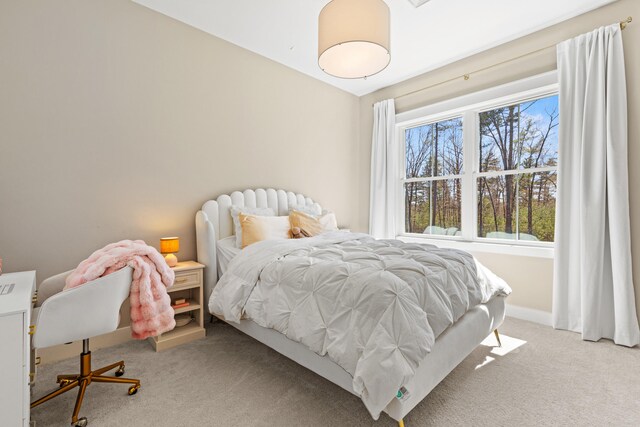 bedroom featuring carpet and baseboards