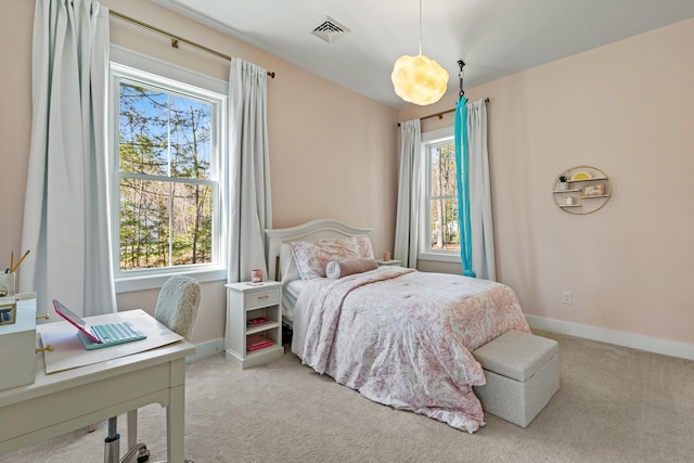 bedroom featuring light carpet, baseboards, and an office area