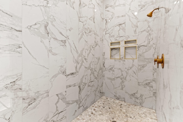 full bath with a marble finish shower