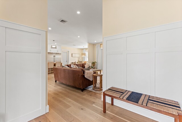 hallway with light wood finished floors and recessed lighting