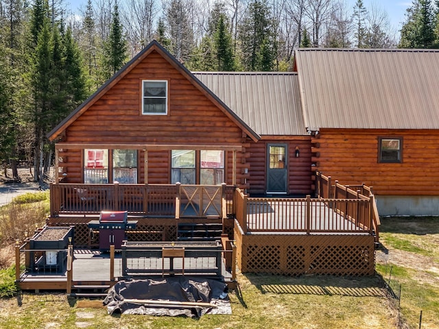 291 River Rd, Milo, ME 04463 - rear view of property featuring metal roof, log siding, and a wooden deck