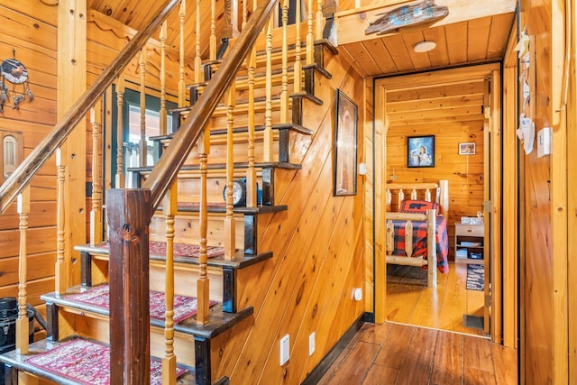 291 River Rd, Milo, ME 04463 - stairway with wood ceiling, wood walls, and hardwood / wood-style floors
