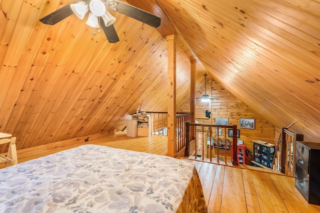 291 River Rd, Milo, ME 04463 - bedroom with vaulted ceiling, wooden walls, and hardwood / wood-style flooring