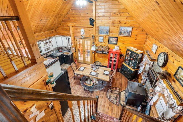 291 River Rd, Milo, ME 04463 - living room with french doors, wood walls, wooden ceiling, vaulted ceiling, and hardwood / wood-style flooring