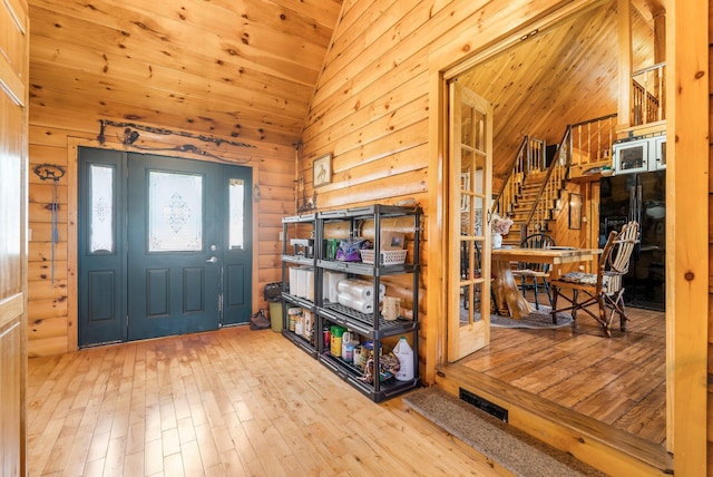 291 River Rd, Milo, ME 04463 - foyer featuring stairs, vaulted ceiling, wooden walls, wood-type flooring, and wood ceiling