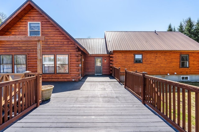 291 River Rd, Milo, ME 04463 - back of house featuring a deck, metal roof, and log siding