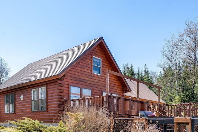 291 River Rd, Milo, ME 04463 - view of side of home featuring log siding, a wooden deck, and metal roof