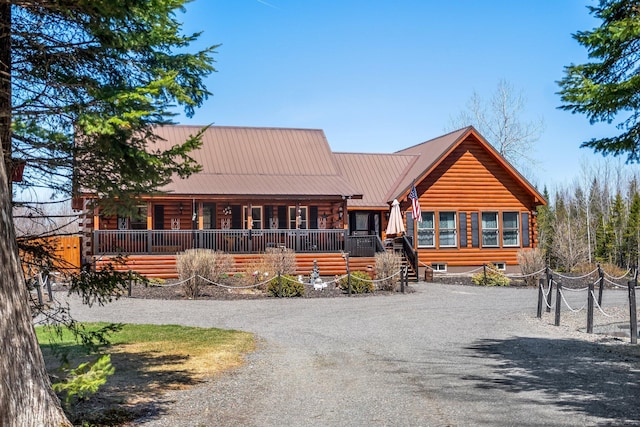 291 River Rd, Milo, ME 04463 - log cabin with a porch, metal roof, and log exterior