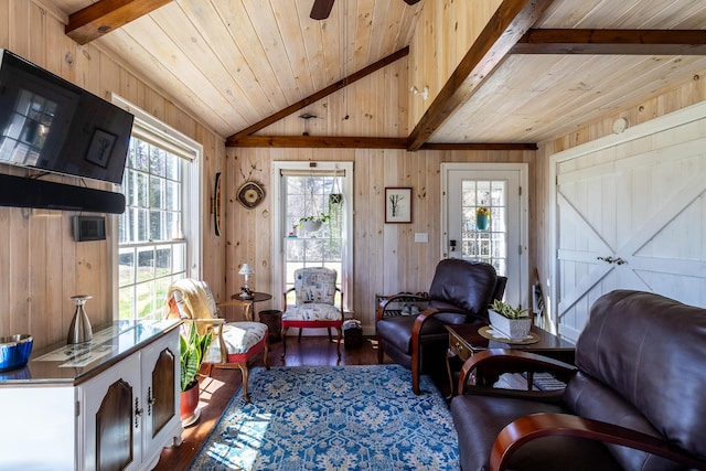 living room featuring hardwood / wood-style flooring, wood ceiling, plenty of natural light, and wood walls