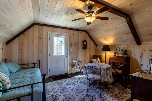 interior space with lofted ceiling, ceiling fan, wood ceiling, wood walls, and wood finished floors