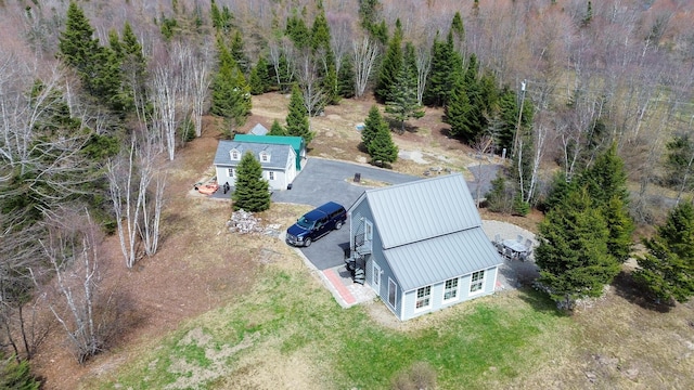 birds eye view of property with a view of trees