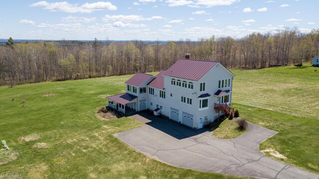 birds eye view of property featuring a wooded view
