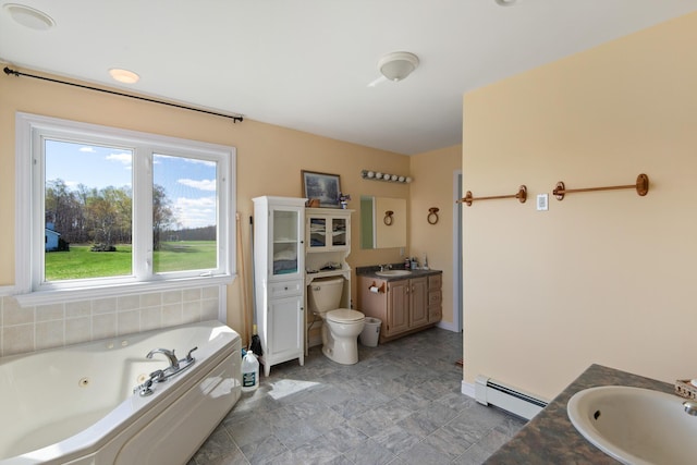 bathroom with vanity, a baseboard radiator, a whirlpool tub, baseboards, and toilet