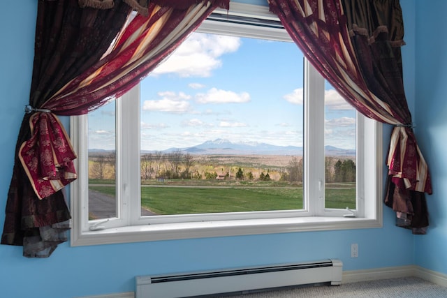 interior details featuring baseboards, a baseboard heating unit, and a mountain view