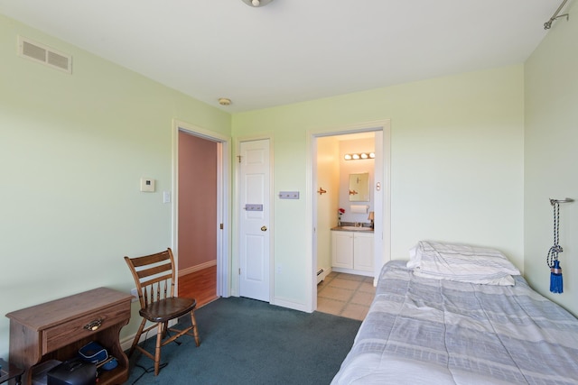 carpeted bedroom with baseboards, baseboard heating, connected bathroom, and visible vents