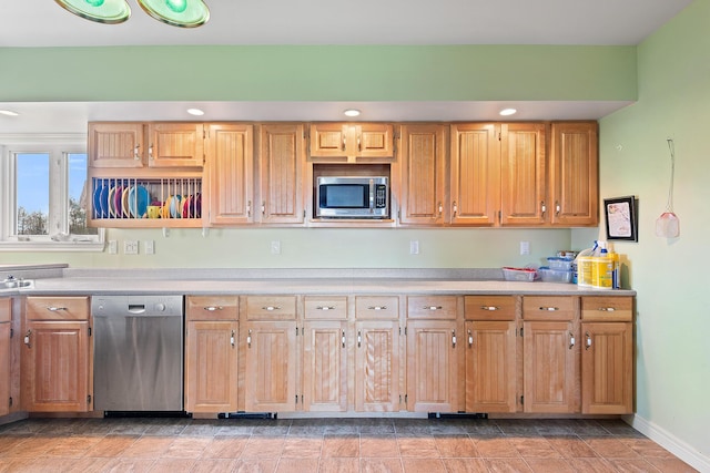 kitchen with light countertops, recessed lighting, baseboards, and appliances with stainless steel finishes