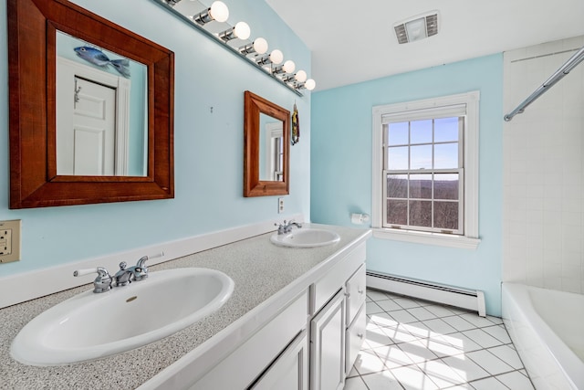 full bath with double vanity, visible vents, baseboard heating, and a sink