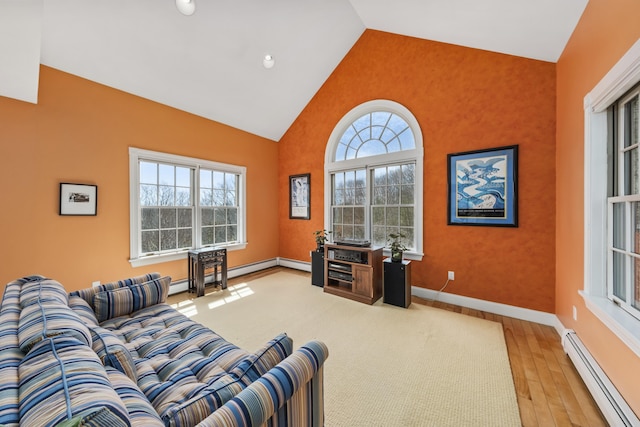 living area featuring baseboard heating, light wood-style flooring, baseboards, a baseboard heating unit, and high vaulted ceiling